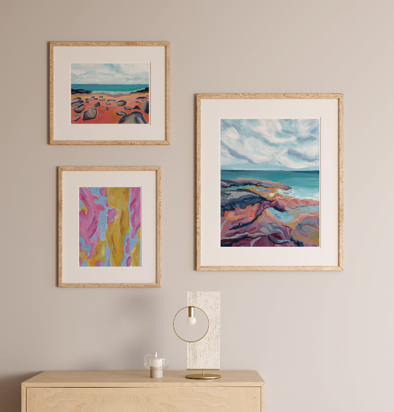 Three framed beach landscape prints with seascape and colorful sand scenes