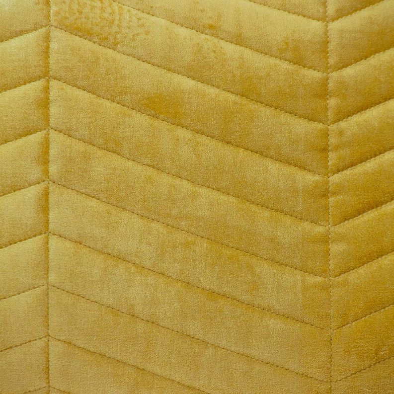 Close-up of yellow lumbar pillow quilting with stitched channel lines