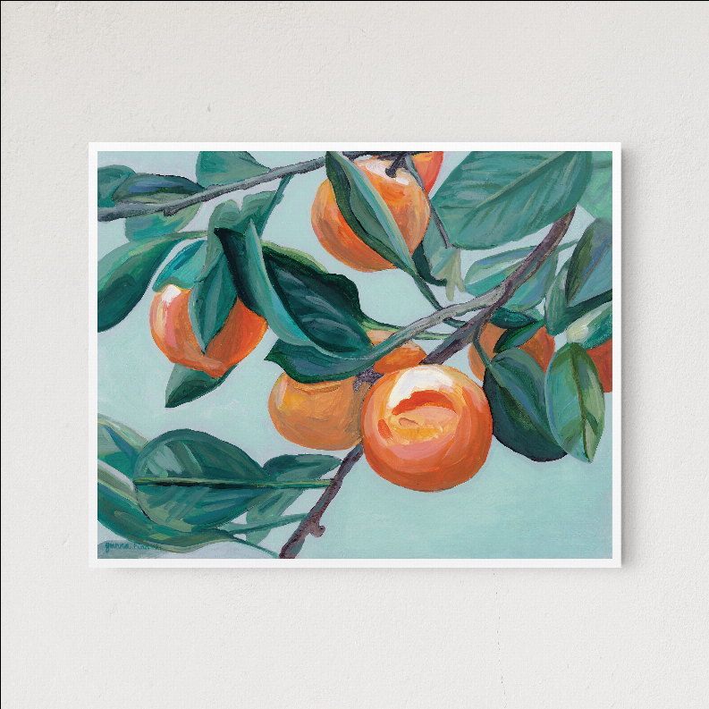 Framed botanical wall art print featuring orange fruit and green leaves on a light background