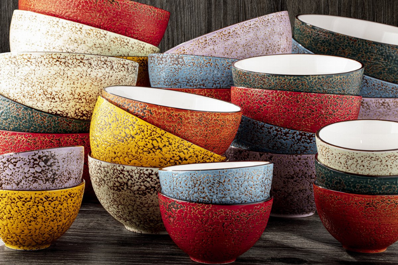 Set of speckled ceramic bowls in mixed colors, white rims and interiors