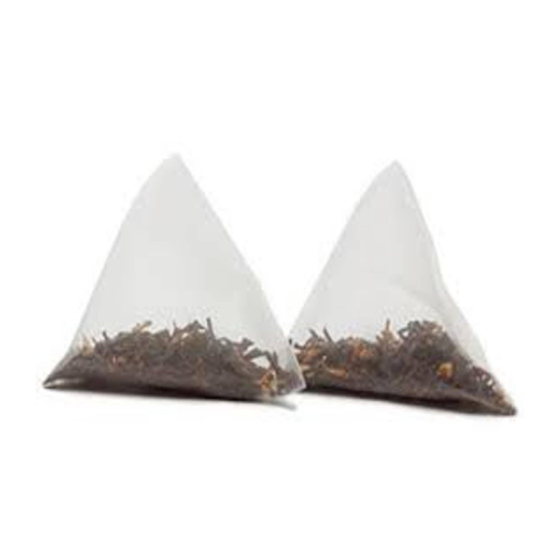 Two triangular tea filter sachets filled with dark tea leaves