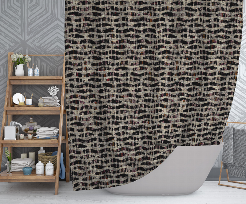 Multi-color abstract shower curtain draped on bathtub