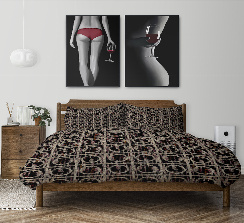 Dark patterned comforter set with two matching pillows on a wooden bed frame