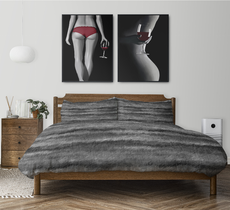 Dark gray duvet cover set with two pillow shams on a wooden bed frame
