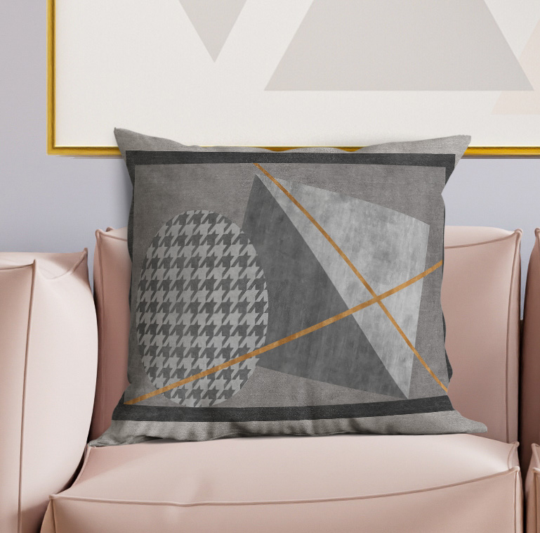 Geometric decorative pillow with charcoal front, gold diagonal lines, and houndstooth motif