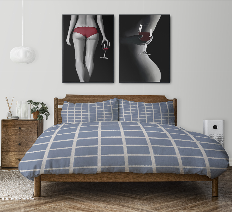 Blue grid comforter on bed with two matching pillow shams