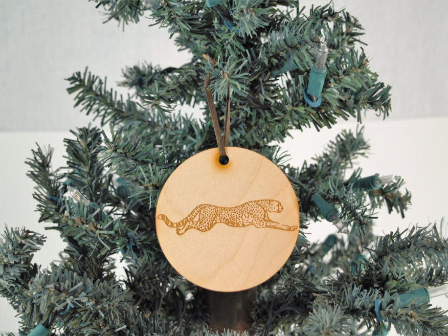 Unfinished wooden jaguar tree ornament, round disc with hanging hole and jaguar outline