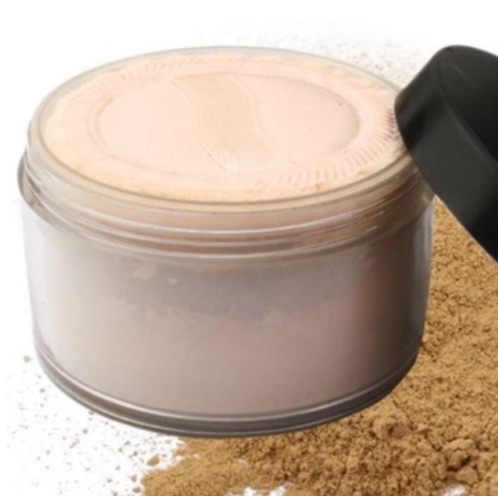 Mineral powder jar with beige powder and textured lid; powder dust on surface