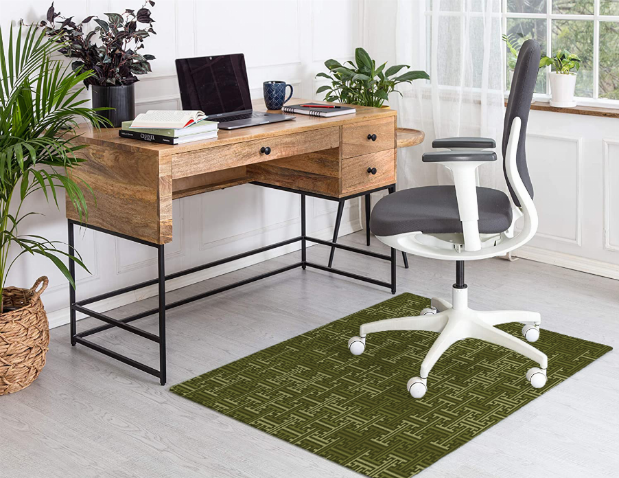 Low pile green carpet with Greek key pattern, centered under a desk chair.