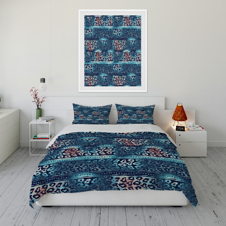 Blue patterned comforter set with two pillow shams on a bed