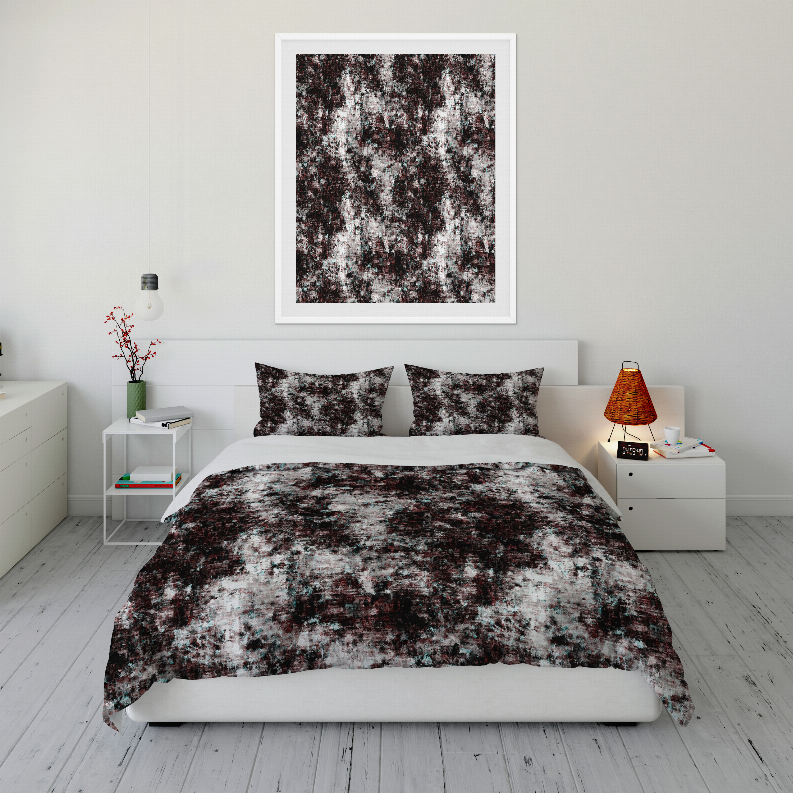 Abstract dark and white comforter set with two matching pillow shams on a bed