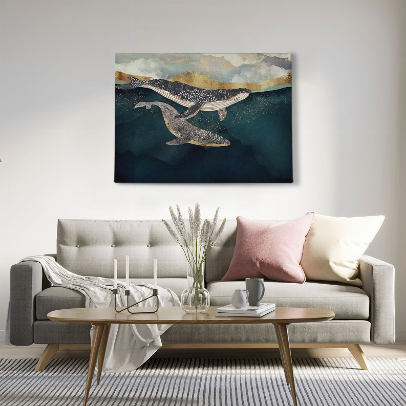 Framed wall art print featuring two whales in teal water beneath pale cloudy sky