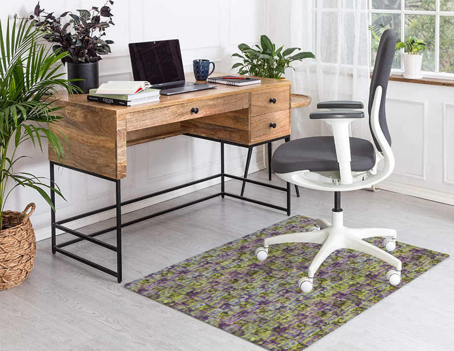 Low-pile carpet with colorful abstract grid pattern in purple, green, and yellow