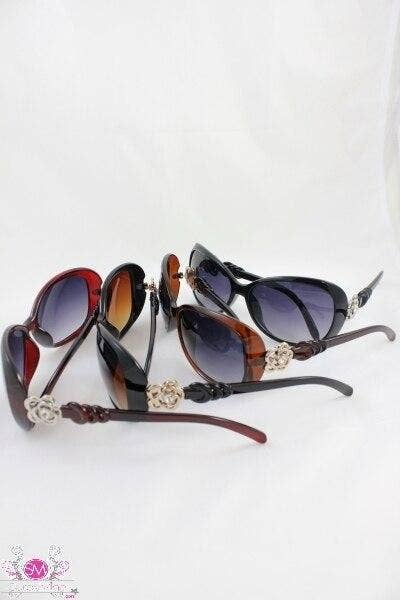 Set of fashion sunglasses with purple-tinted lenses, showing red, tortoiseshell, and black frames