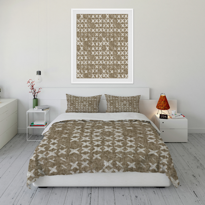 Taupe and white geometric comforter set with two pillow shams on a bed