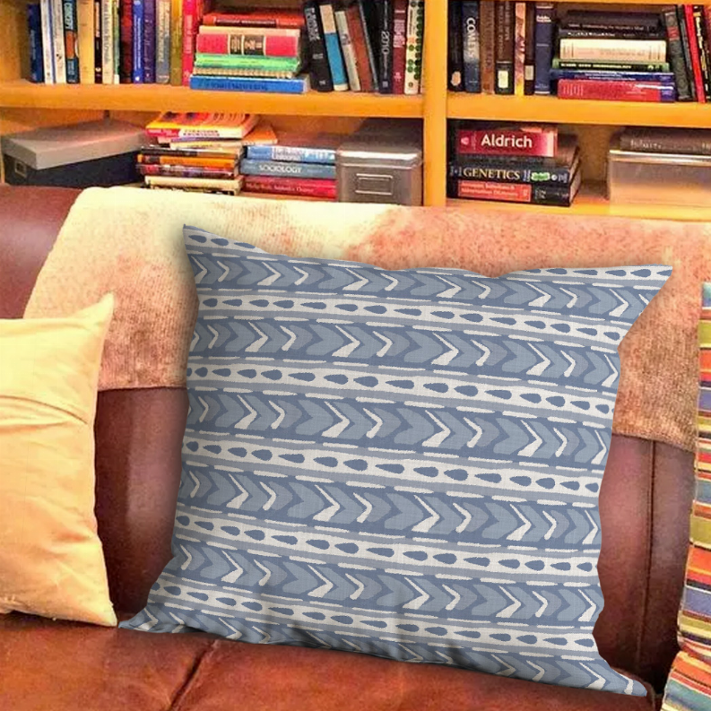 Square throw pillow in blue and gray with arrow stripe and dot pattern, front view