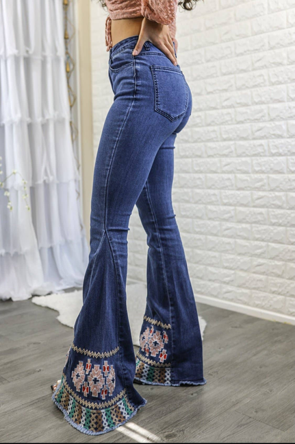 Women’s dark blue flared bell-bottom jeans with multicolor embroidered hem trim