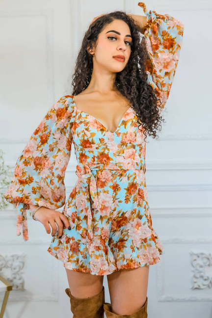 Floral long-sleeve romper with V-neck and ruffled tiers; side view, orange/pink floral print