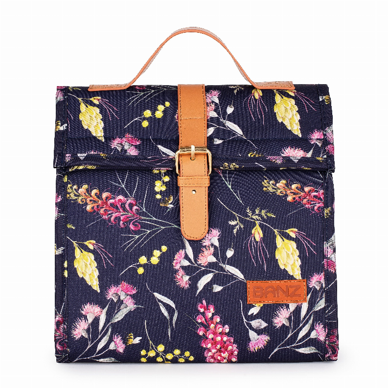Lunch cooler bag with navy floral print, tan handle strap and front logo patch
