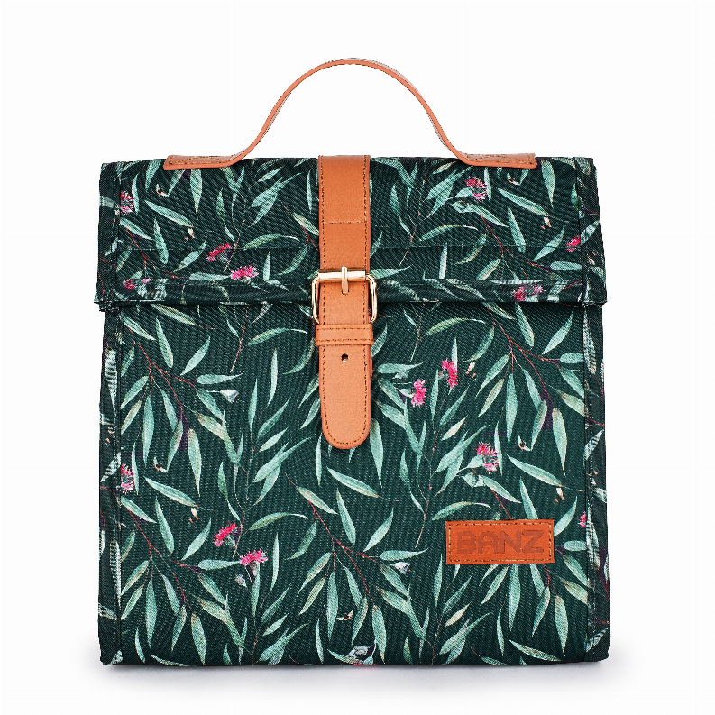 Lunch cooler bag with dark green leaf print, tan handle strap and front logo patch