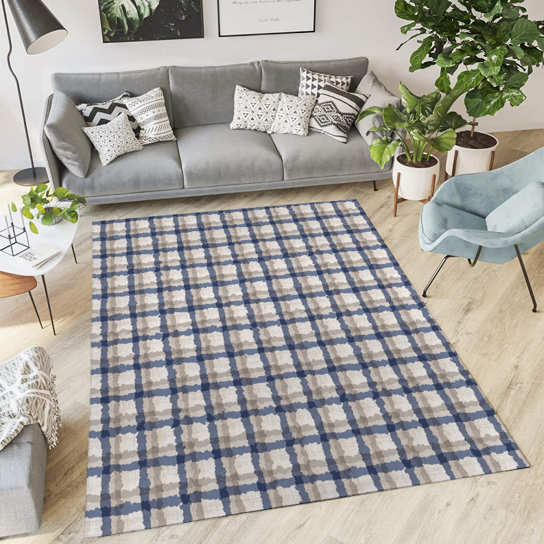 Low pile carpet rug with blue and cream checkered pattern on light wood floor