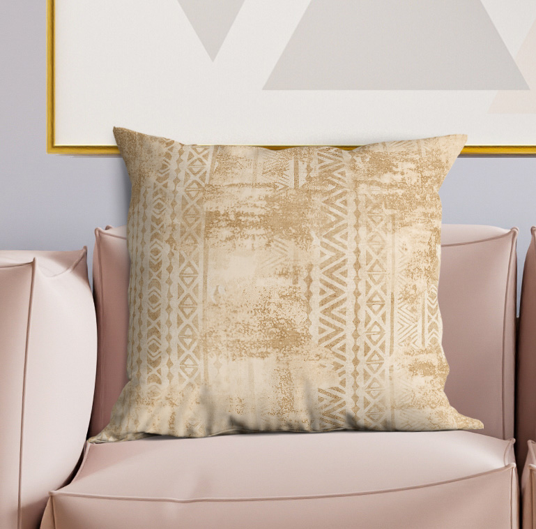 Beige square throw pillow with centered geometric pattern and textured finish