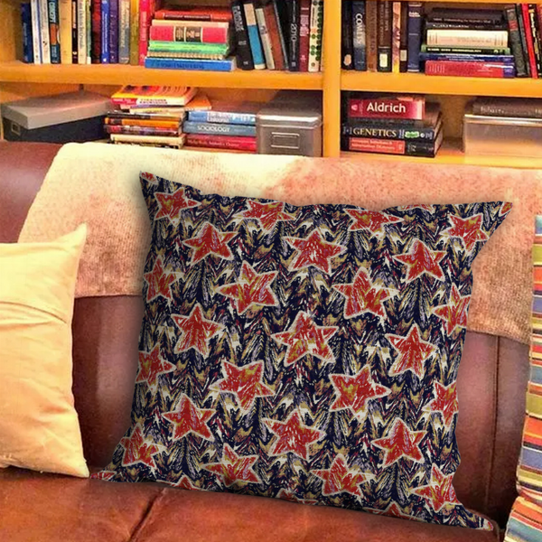 Square throw pillow with multicolor star pattern on dark fabric