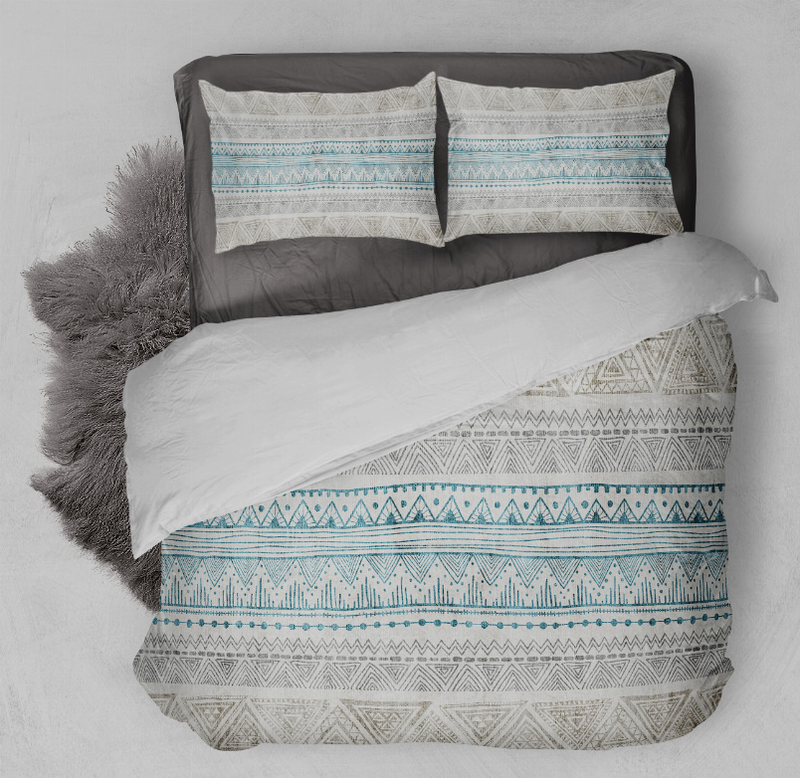 Blue and gray patterned comforter set with two pillow shams, close-up