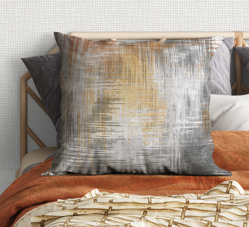 Square decorative pillow with orange and blue abstract grid on gray fabric