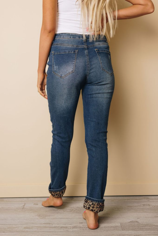 Blue straight-leg jeans with leopard ankle cuffs and patchwork distressed rips
