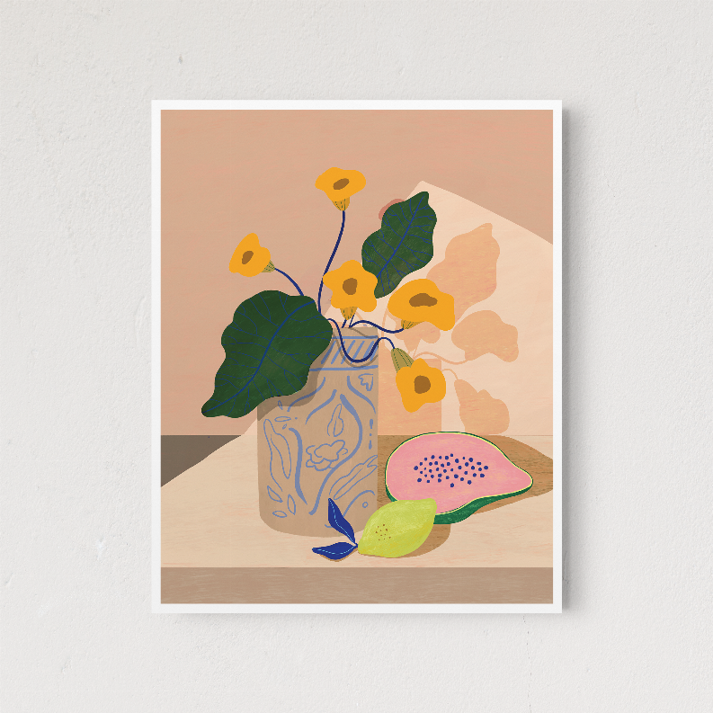 Framed floral illustration print showing yellow flowers, green leaves, and a pink fruit slice