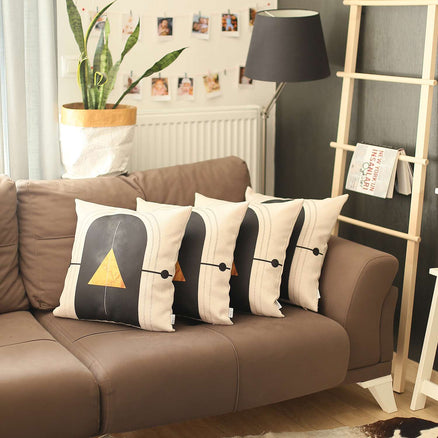 Boho throw pillow covers with black arch, gold tree motif, and gold stripe trim (on sofa)