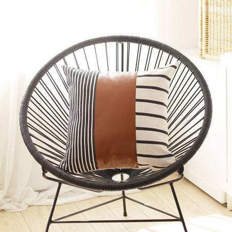 Striped throw pillow cover with brown panel and black-and-white vertical and horizontal stripes
