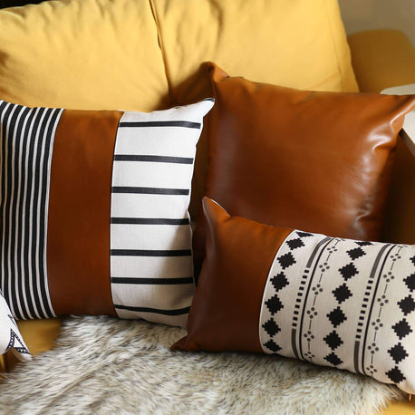 Brown faux leather throw pillow with white-and-black striped and diamond pattern cushions