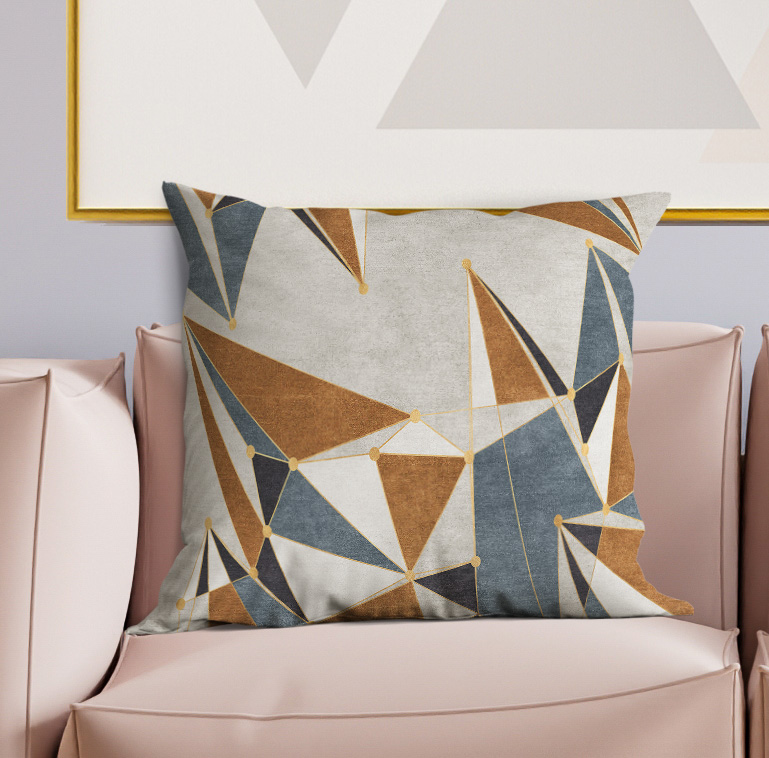 Geometric throw pillow with gray background and blue/tan/white abstract star triangles
