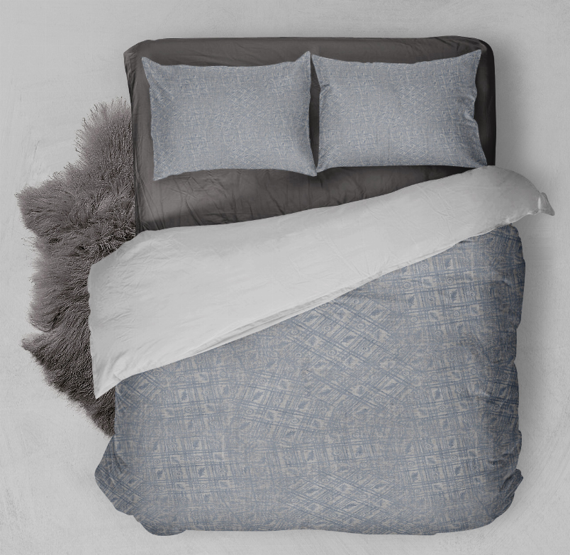 Blue patterned duvet cover set with two pillow shams and white blanket