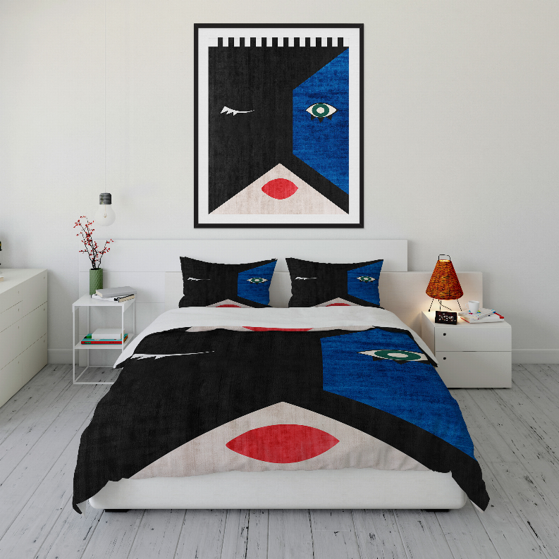 Comforter set on bed with black, blue, and red abstract geometric pattern; two pillows.
