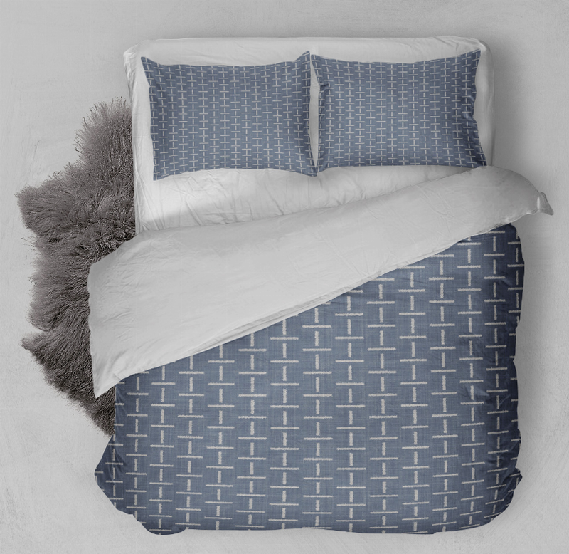 Blue comforter set with white grid pattern and two pillow shams