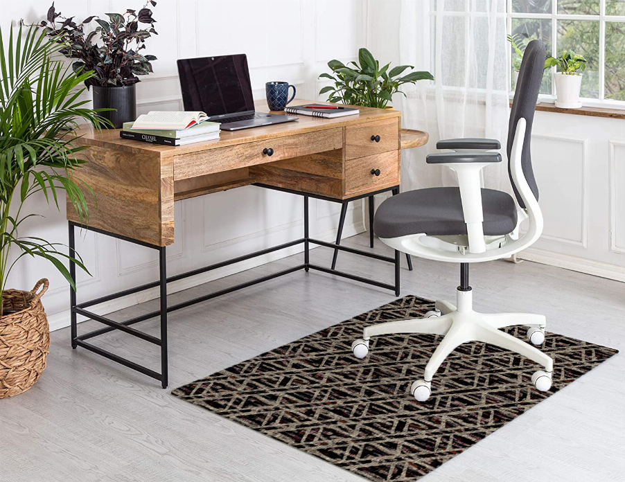 Low pile carpet with multicolor geometric pattern, corner view on dark base