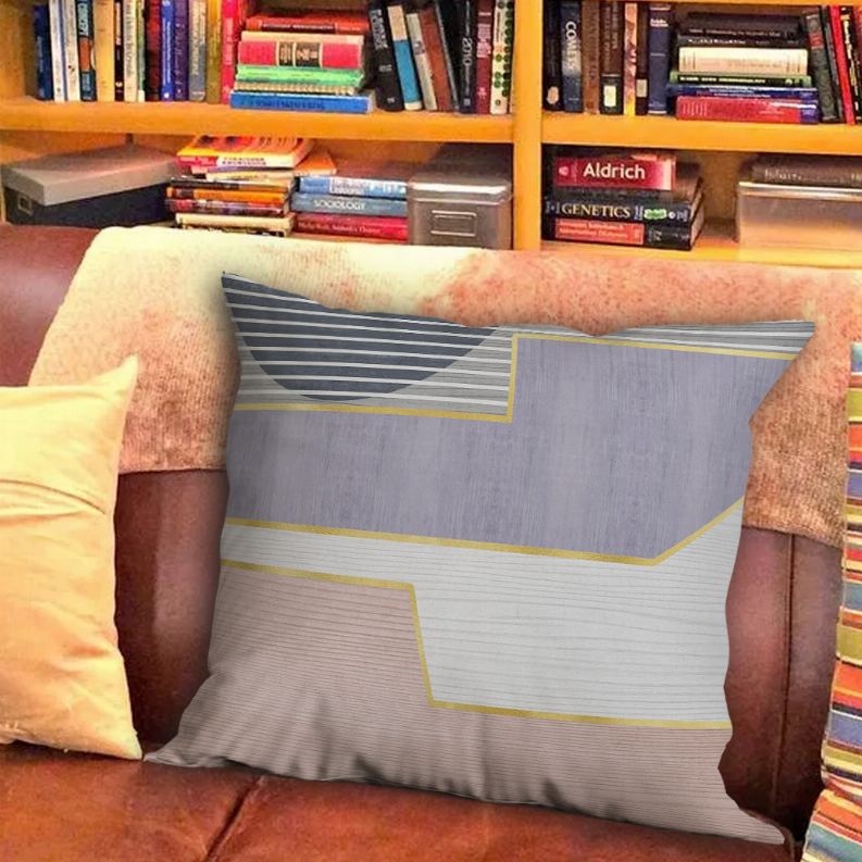 Geometric throw pillow in gray, white, navy stripes with yellow-bordered shapes