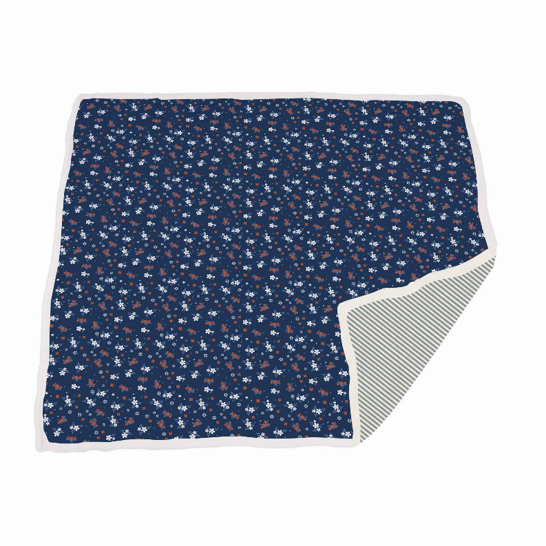 Bamboo muslin blanket, navy floral print with orange and white flowers; striped underside edge.