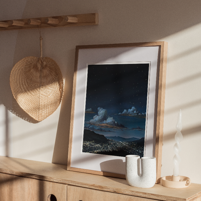 Wood-framed night landscape wall art with mountains, clouds, and bright lights below