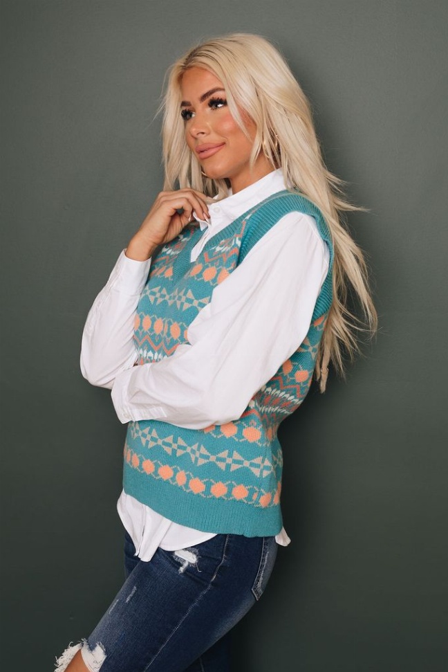 Teal sleeveless knitted vest with V-neck and orange/cream tribal design