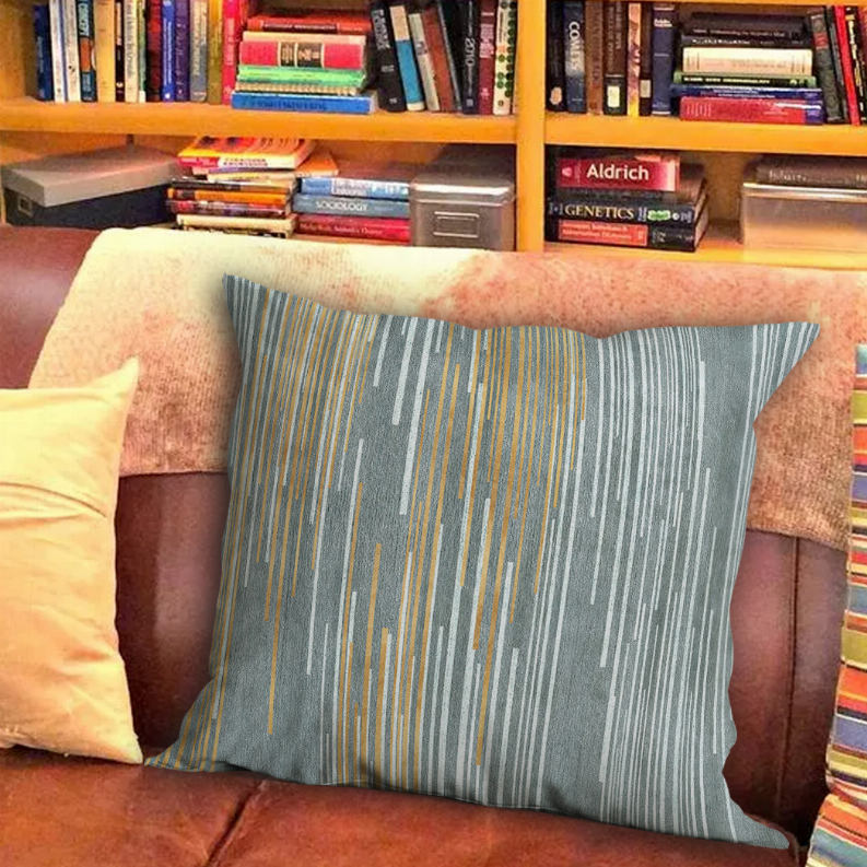 Square teal striped pillow with gold and light gray vertical streaks