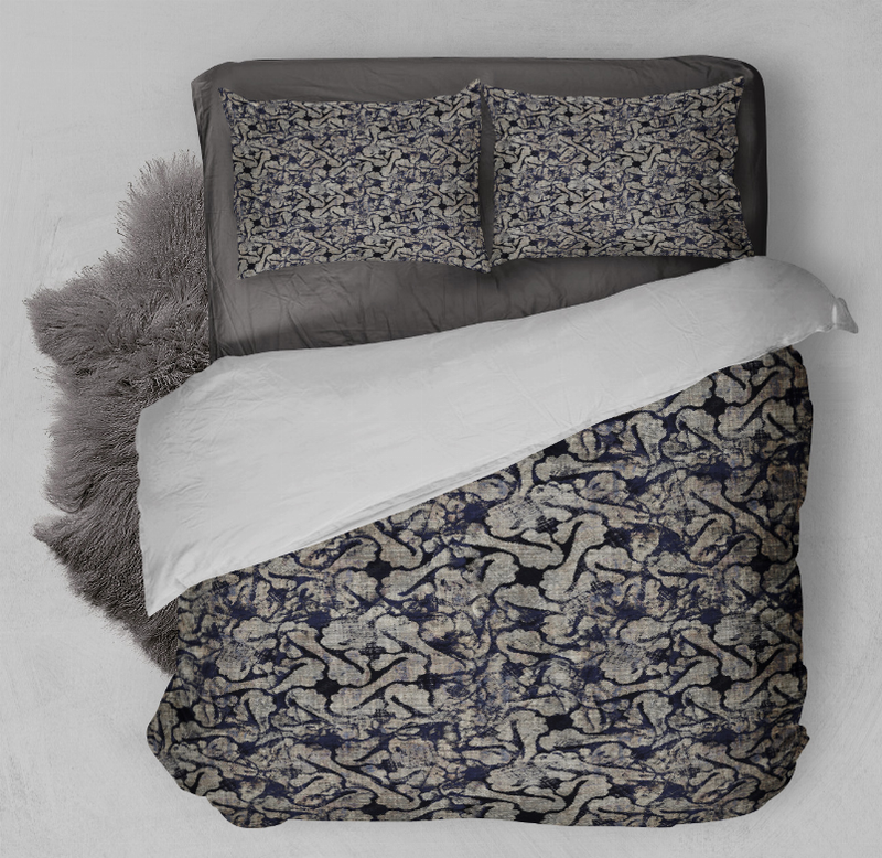 Navy and black patterned comforter set with two shams, laid flat on bed