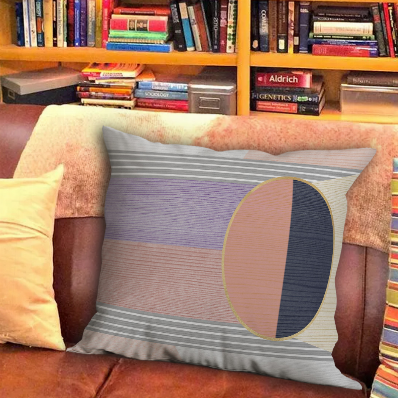 Multi-stripe throw pillow with large orange and navy oval center panel