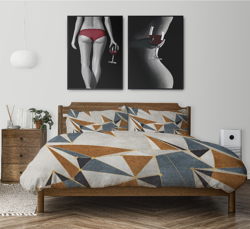 Geometric comforter set on wooden bed frame; white, tan, blue, and dark gray triangles
