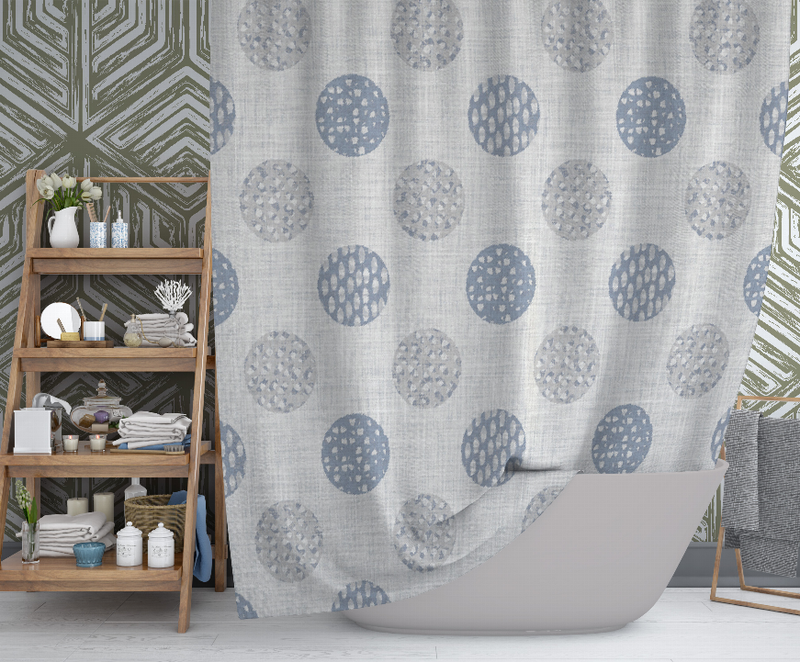 Shower curtain with repeating dotted circles in blue and gray on a light fabric