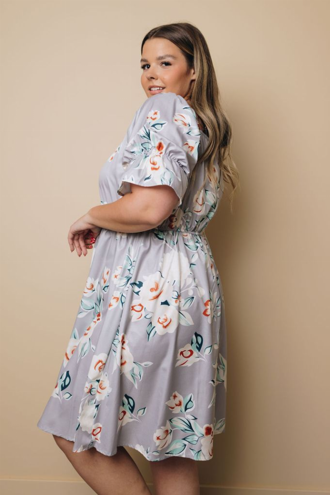 Light blue floral midi dress with puff sleeves and gathered waist, side view