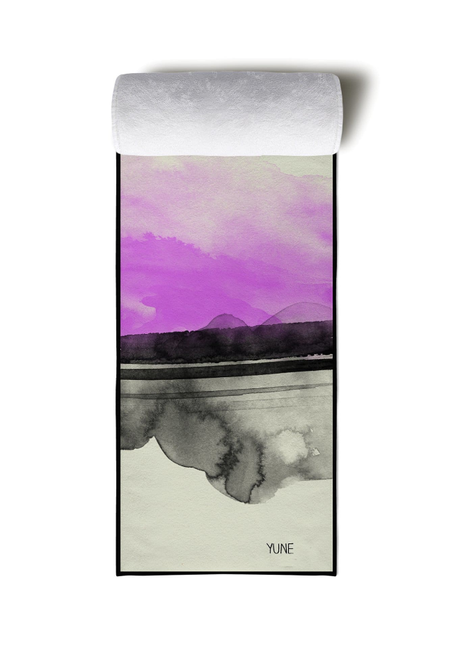 Yoga towel with rolled gray edge, lavender sky and mountain scene, YUNE text.